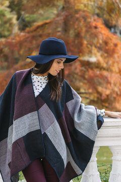 Autumn fashion with elegant woman in stylish poncho