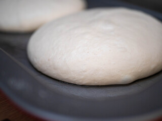 Two Perfect Balls of Pizza Dough Proofing on a Baking Tray