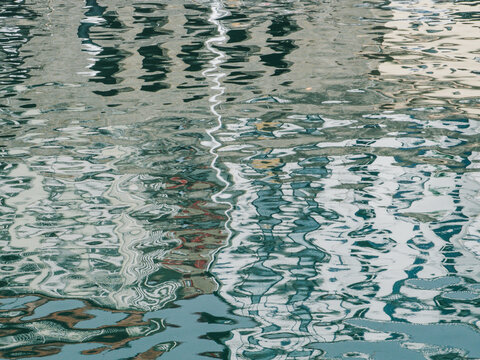 Abstract urban reflection on rippling water surface