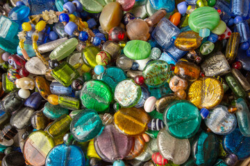 Collection of multicolored glass and stone beads, for creating jewelry and decorative crafts, a vibrant textural abstract.