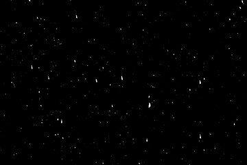 White paint splatter over black wall surface