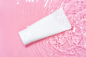 Cosmetic package splashing in pink water