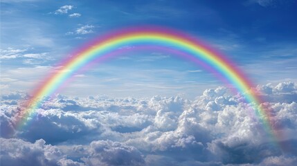 Rainbow arches over fluffy clouds in a vibrant sky
