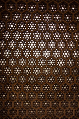 This image features an ornate hexagonal stone lattice, embodying Mughal heritage with its elegant cutouts for light filtration and shadow play. Designers, use this as a decorative partition for privac