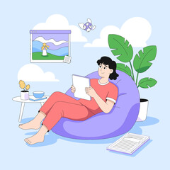Obraz premium Woman relaxing in a beanbag chair reading a book in a cozy room.