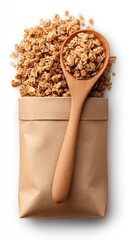 Light brown granola in a paper bag with a wooden spoon