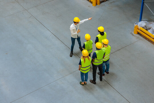 Warehouse manager delegating tasks to his workers