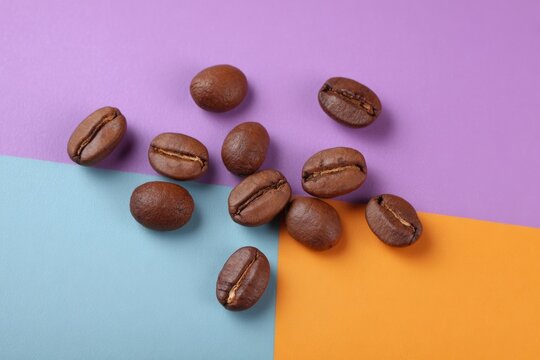 Coffee beans dance on vibrant geometric pastels, embracing International Coffee Day magic and cosmic color geometry fascination