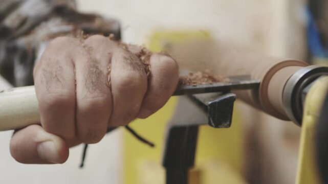 Man crafting a flute using traditional woodworking tools