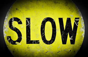 Dirty yellow slow caution sign