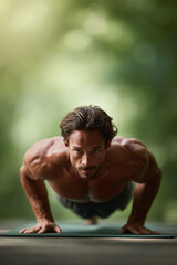 Intense man doing pushups, outdoors, strength, fitness, and determination. Ideal for health, wellness, sports, and active lifestyle marketing. Motivation and focus.