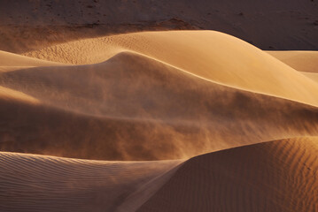 Sandstorm on Golden Sand Dunes at Sunset