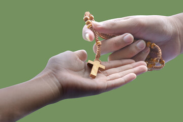 isolated hand holding wooden cross or crucifix rosary with clipping paths.
