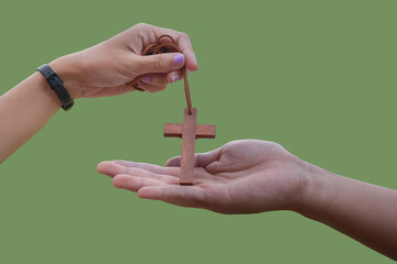 isolated hand holding wooden cross or crucifix rosary with clipping paths.