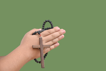 isolated hand holding wooden cross or crucifix rosary with clipping paths.