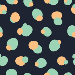 Abstract Geometric Bubble Pattern in Green and Orange on Dark Background