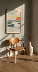 Framed abstract seascape print on a light-colored wall, with a light wooden chair and vase in the foreground, bathed in natural light