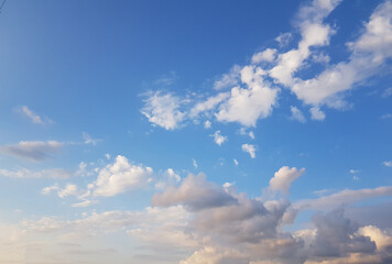 Summer blue sky with white floating clouds