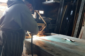 Industrial worker with work tools. Welding indoor