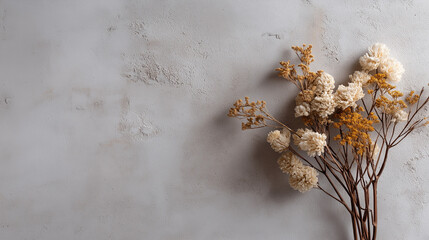 Dried flowers against textured plaster wall with copy space