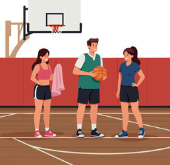 Young people playing basketball on indoor court with hoop and wooden floor active lifestyle scene