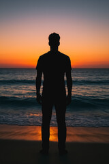 Man Silhouette at Sunset: A solitary figure stands silhouetted against the mesmerizing backdrop of the setting sun over a tranquil ocean, embodying reflection and contemplation. 