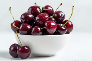 Bowl of fresh cherries on a white background. Commercial product shoot, sharp focus. Sweet ripe cherry fruits. Side view, food magazine, minimalist, clean and simple. Fresh big cherries with stems.