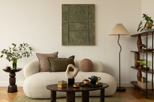 Contemporary living room with white sofa, decorative pillows, sculptural objects, coffee table with tea set, and wall art in green tones. Mock up paintings. - Powered by Adobe