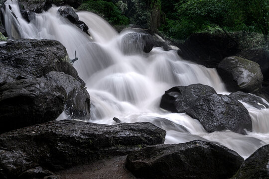 El Molino waterfall in Valle de Bravo, Mexico, framed by dense forest trees, cascading water shaping a hidden natural scene ideal for eco tourism, adventure hiking, and green travel exploration