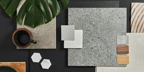 Flat lay composition of creative black architect moodboard with samples of building, textile and natural materials and personal accessories. Top view, black backgroung, template.