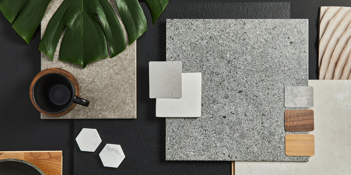 Flat lay composition of creative black architect moodboard with samples of building, textile and natural materials and personal accessories. Top view, black backgroung, template.