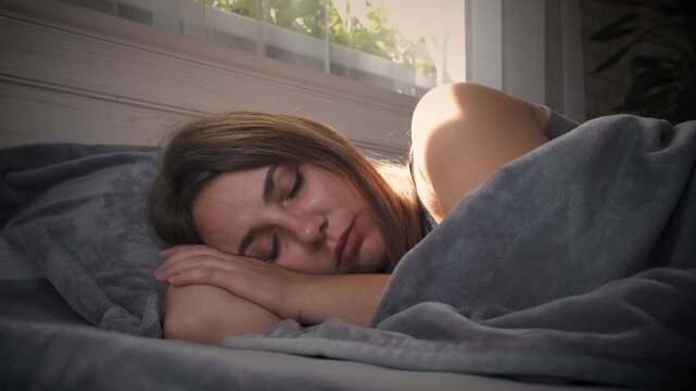 Sad woman lying in bed, cinematic emotional scene