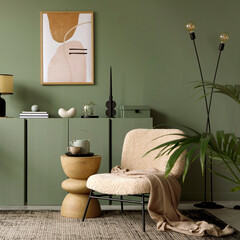 Elegant living room interior design with mockup poster frame, modern frotte armchair, wooden commode and stylish accessories. Green eucalyptus wall. Template. Copy space.