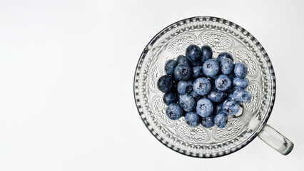 Intricate crystal bowl cradles plump blueberries, evoking Midsummer's Eve feasts and antioxidant-rich indulgence in Nordic traditions