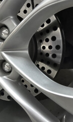 Sleek metallic car wheel echoes precision and speed, embodying Gearhead Festival vitality and craftsmanship's labyrinthine elegance