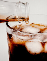 Effervescent cola cascade over glistening ice cubes, evoking summer solstice gatherings and World...