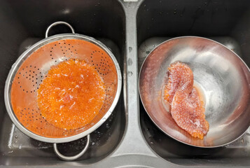 Salmon roe glistening like sunset pearls in colander, Nordic culinary tradition, Midsummer feast, mingling sea's secret bounty