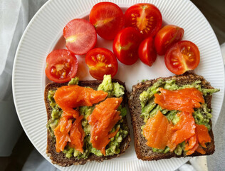 Sublime brunch intertwining velvety avocado toast with vibrant smoked salmon and tomatoes, echoing...