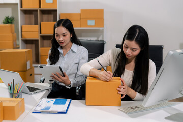 Small business entrepreneur SME freelance woman working at home office, boxs ,tablet and laptop...