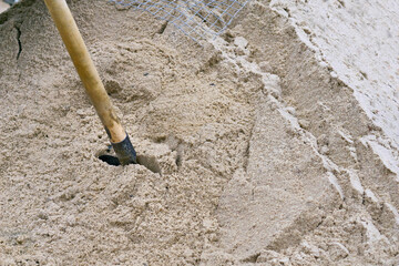 Shovel in a pile of sand at a construction site
