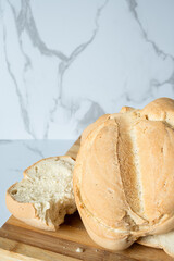 Freshly baked homemade bread resting on wooden cutting board