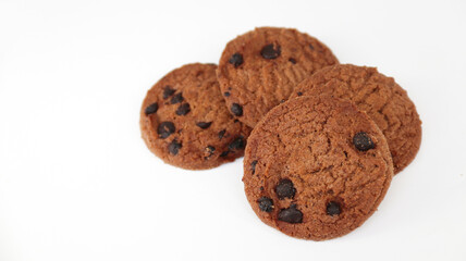 Isolated clipping path of die cut dark chocolate chip cookies on white background. Closeup tasty bakery organic homemade American biscuit sweet dessert