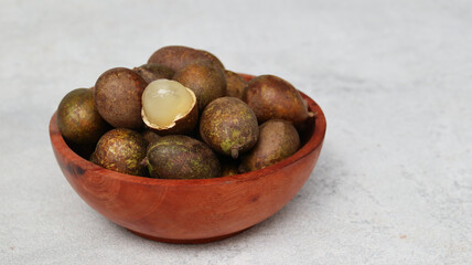Matoa (Pometia pinnata) on wooden bowl