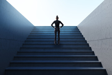 Businesswoman standing at the base of a large modern staircase, symbolizing ambition and career growth in a corporate setting with bright sky above.