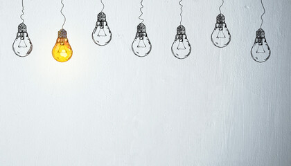 Glowing hand-drawn lightbulb among unlit sketch bulbs on white wall background symbolizing creative...