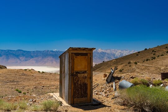 Rustic outhouse in desert landscape - Powered by Adobe