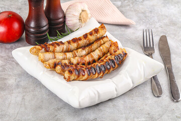 Grilled meat sausages wrapped bacon