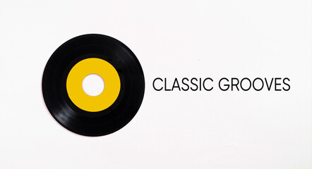 Classic vinyl record with yellow label on white background representing classic grooves
