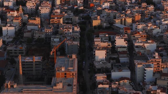 Aerial view of Chania town in Crete, Greece, with a slow pan revealing urban architecture, the White Mountains, and warm golden hour lighting.