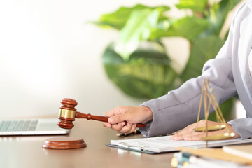 Legal Authority. Lawyer striking gavel in office, emphasizing decision-making.